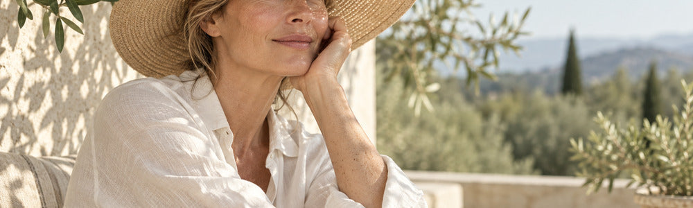 Mature woman wearing a sun hat and long sleeves to protect sun-damaged body skin