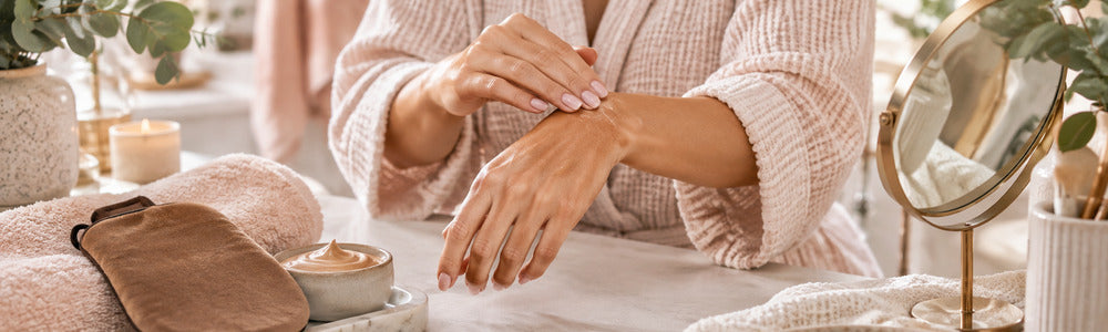 Hands blending self-tanner carefully around the wrist