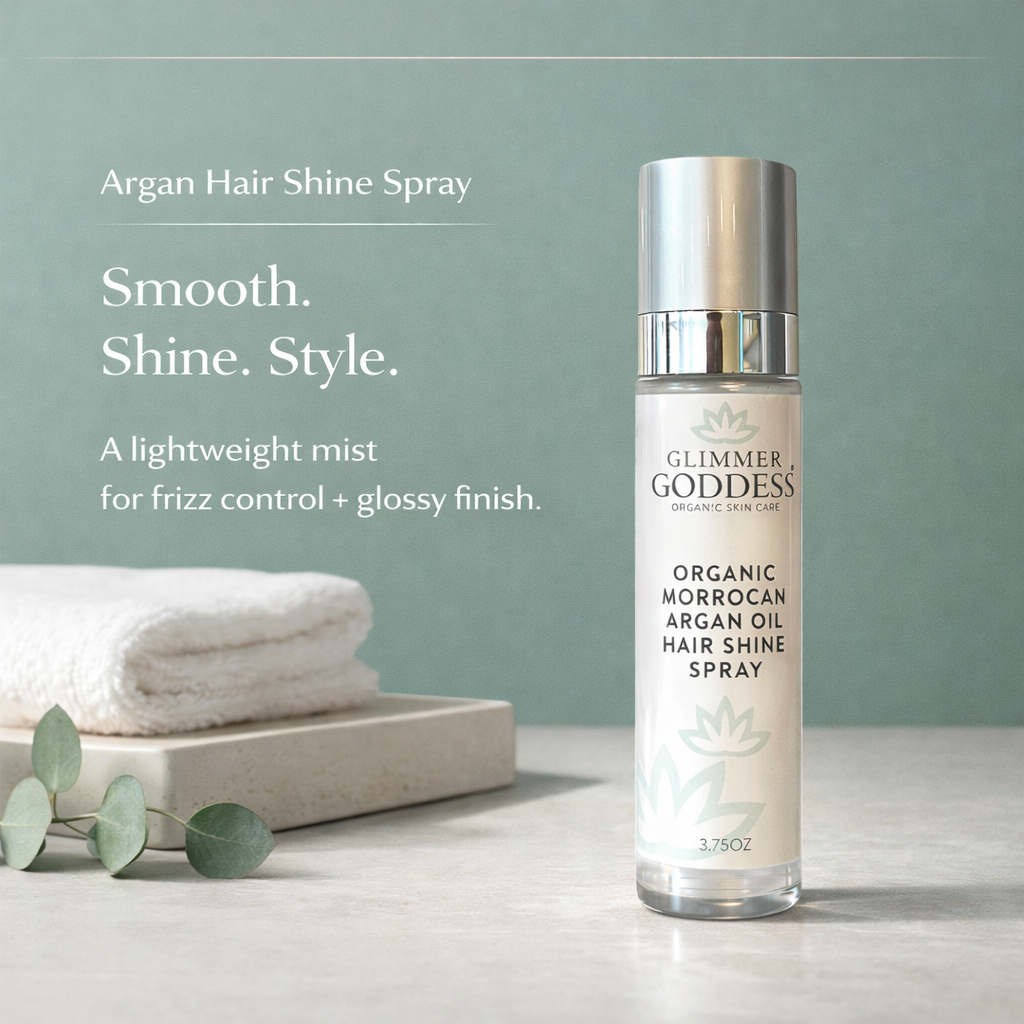 Glimmer Goddess Organic Moroccan Argan Oil Hair Shine Spray (3.75 oz) displayed in a luxury vanity lifestyle scene on a eucalyptus green background with a light stone countertop, highlighting frizz control, glossy shine, and lightweight hydration for smooth, shiny hair.