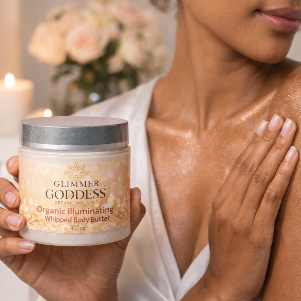 Woman applying Glimmer Goddess Organic Shimmering Body Butter to her shoulder, showing radiant hydrated skin with light-reflecting glow while holding the 4 oz jar – shea butter and cocoa butter moisturizer handcrafted in Texas.