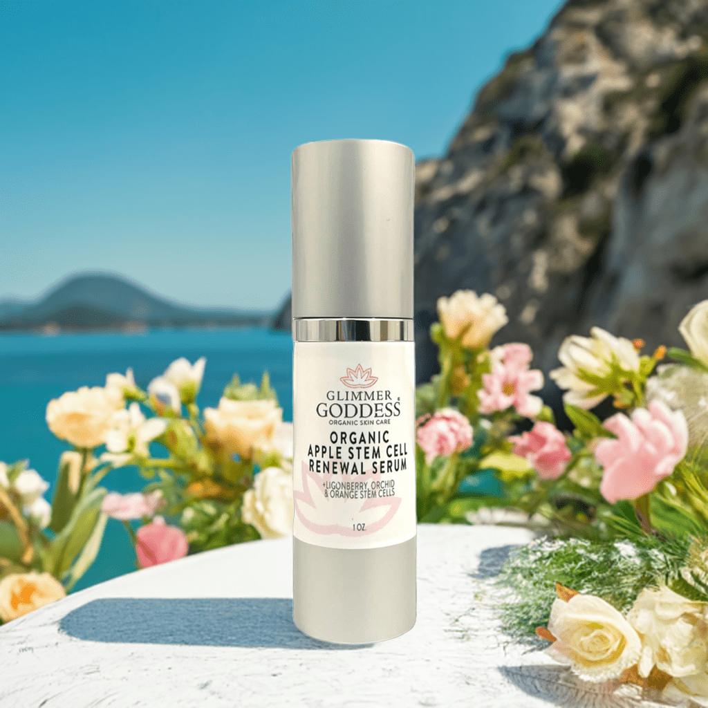 Organic Apple Stem Cell Serum from Glimmer Goddess by flowers in front of ocean
