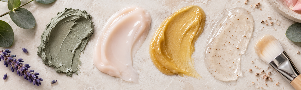 Clay, cream, enzyme and gel face mask textures on ivory stone