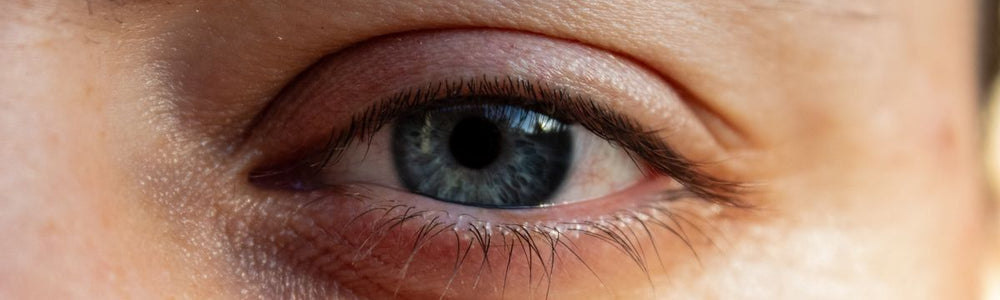 Person gently caring for the delicate skin around the eyelids.