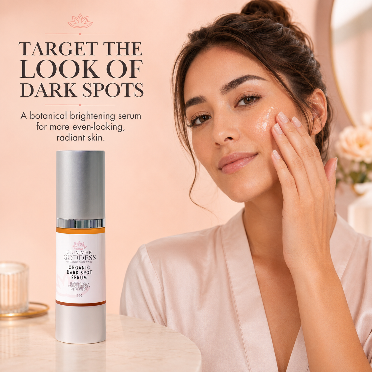 A woman in a pale pink robe applies a brightening cream to her cheek beside a bottle of Summer Goddess Organic Dark Spot Serum on a light marble surface, with soft pink background and promotional text.