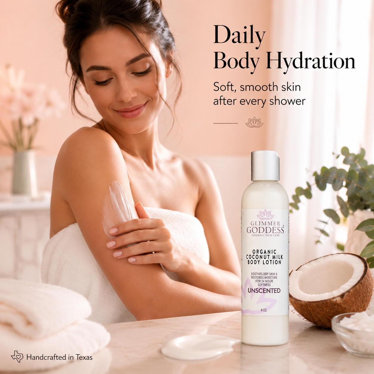 Glimmer Goddess® Organic Coconut Milk Body Lotion lifestyle image showing a woman applying ultra-hydrating body lotion after a shower in a soft peach spa setting, with the bottle, coconut accents, and lotion texture highlighting daily hydration, soft supple skin, and handcrafted clean body care.
