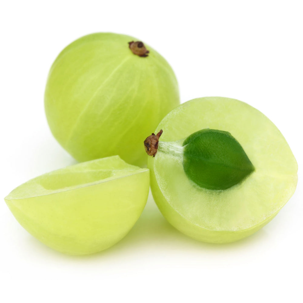 Fresh amla fruit whole and sliced, rich in vitamin C, on a white background