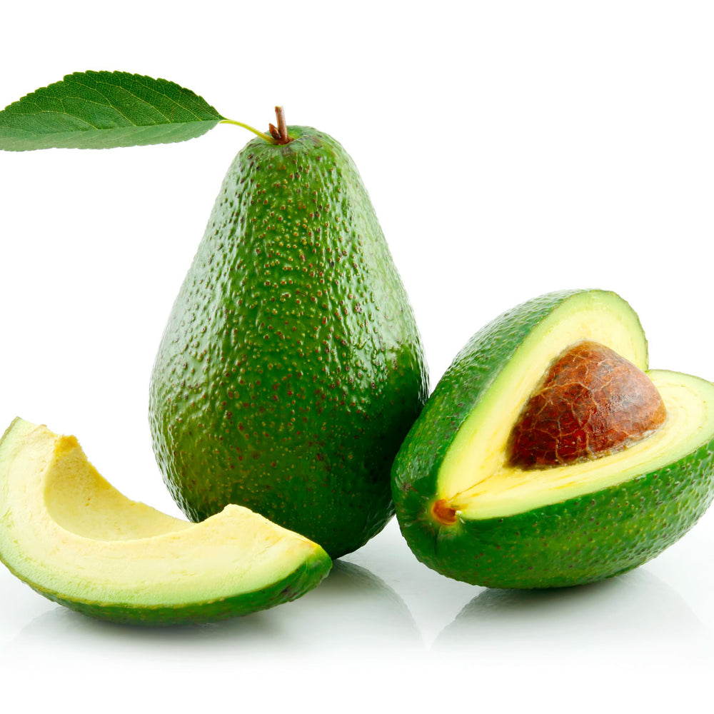 Fresh avocado whole and sliced on white background, rich in vitamins and botanicals