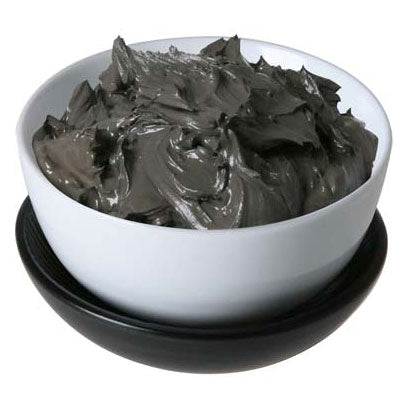 Dead Sea mineral mud in a white bowl, natural skincare ingredient