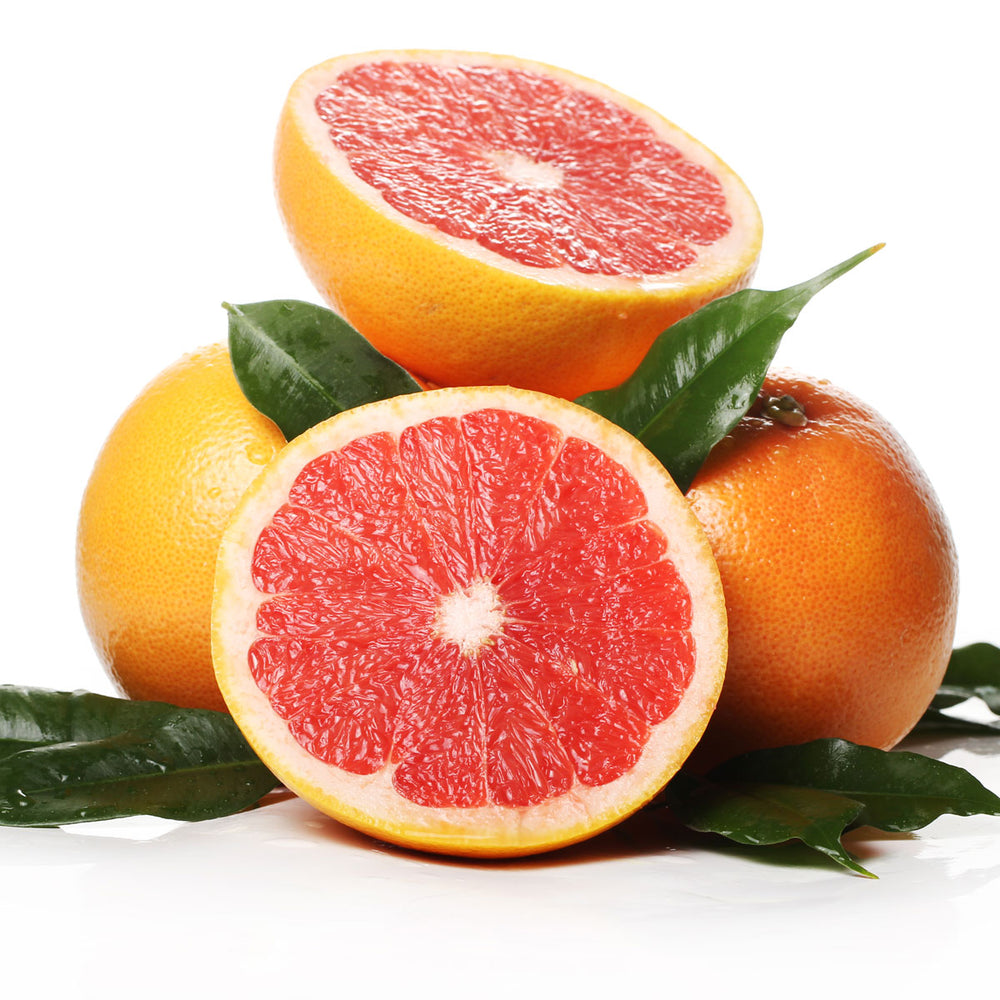 Fresh sliced grapefruit with leaves on white background, citrus ingredient for skincare