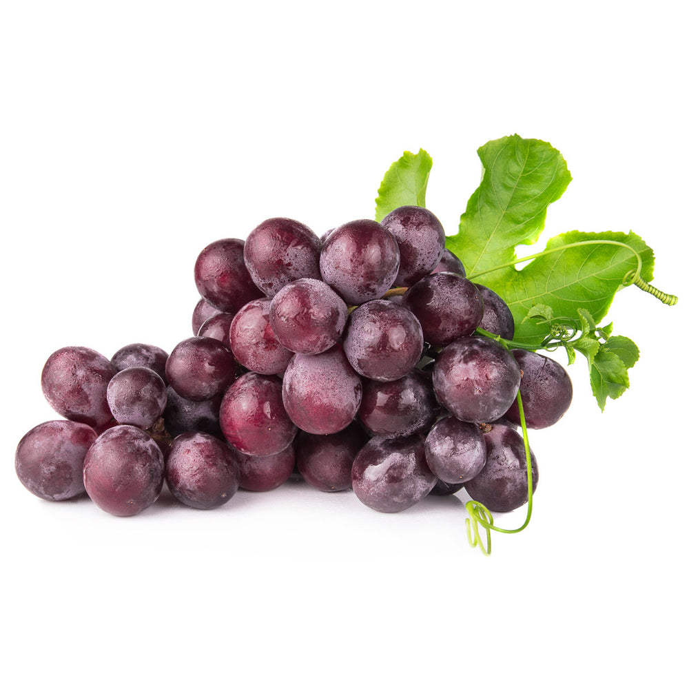 Fresh red grapes with green leaves isolated on white background, rich in antioxidants and nutrients