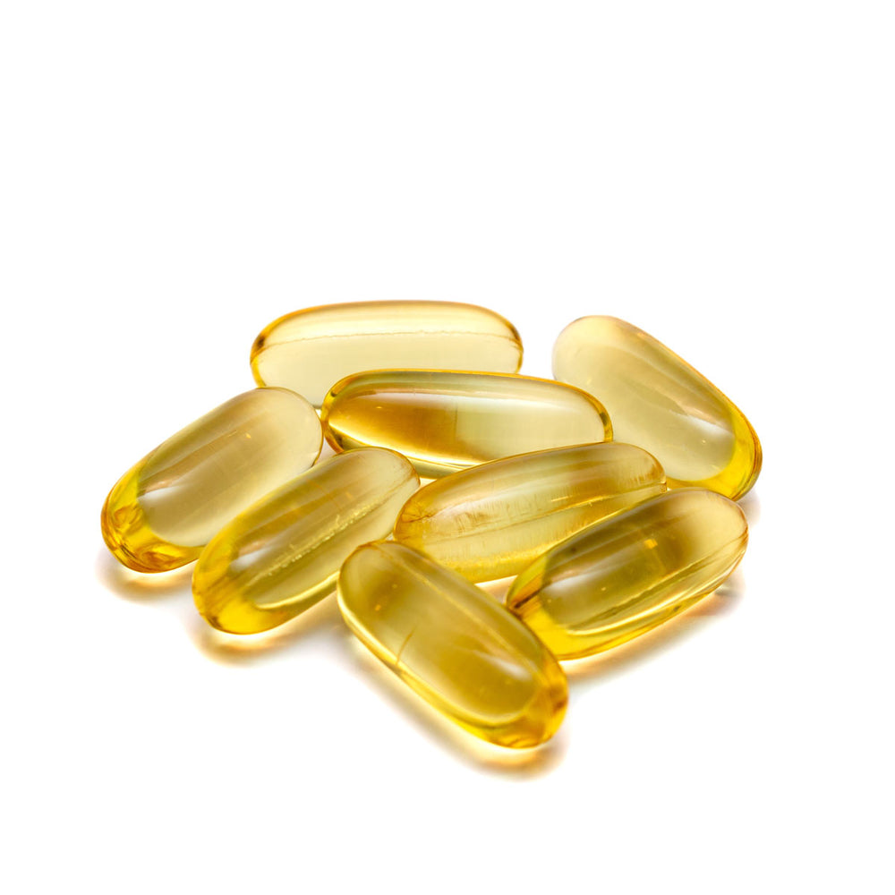 Vitamin E softgel capsules for skincare on white background